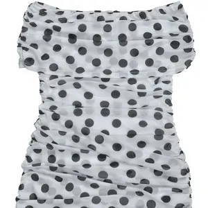 Detailansicht des schwarzen Punktmusters auf weißem Mesh-Bodycon-Partykleid-Stoff