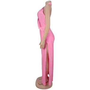 Detailed side view of pink halter backless maxi dress with high slit on mannequin
