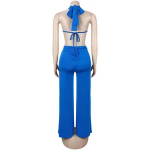 Rear view of a blue sexy backless lace-up jumpsuit featuring a stylish ruched design