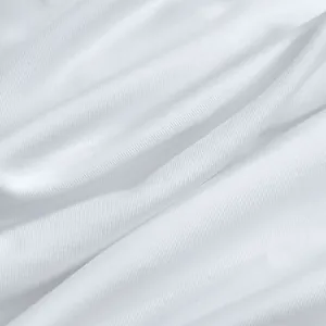 Detailed macro view of soft white pleated fabric texture for women's elegant fashion dress
