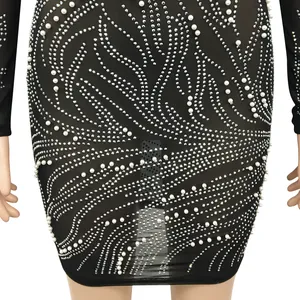 Close-up of sexy black mesh dress featuring elegant pearl and rhinestone details