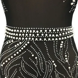 Detail of sexy black mesh dress featuring elegant white pearls and sparkling rhinestones