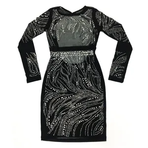 Detailed view of elegant black long sleeve sheer mesh dress featuring white pearl swirl patterns