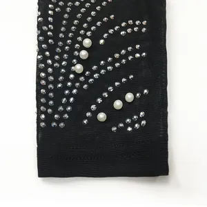 Macro detail of sexy mesh dress featuring sparkling rhinestones and white pearls