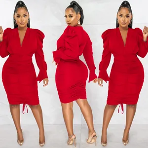Elegant red long sleeve bodycon dress with ruched detailing and a deep V-neckline view.