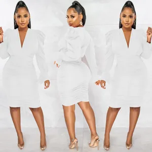 Detailed views of white ruched long sleeve V-neck dress showing bodycon fit.