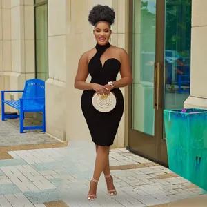 Full-length view of an elegant black halter-neck off-shoulder bodycon dress on a model