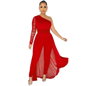 Elegant red one-shoulder jumpsuit with sheer mesh sleeve and flowing overlay detail.