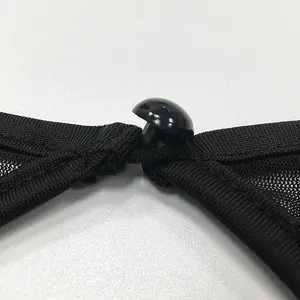 Close-up detail view showing the black button and fine mesh texture of this sheer dress