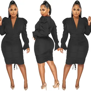 Detailed view of women's black long sleeve ruched V-neck dress with puff shoulders.