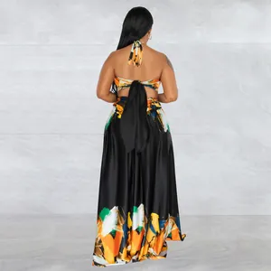 Detail back view of a colorful abstract print backless maxi dress with halter tie.