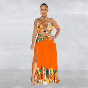 Full length front view of vibrant orange halter neck maxi dress with artistic print and slit