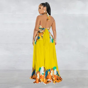 Back view of a vibrant yellow halter maxi dress with artistic brushstroke print