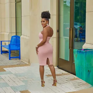 Detailed back view of a stylish pink halter-neck bodycon midi dress with a rear slit.
