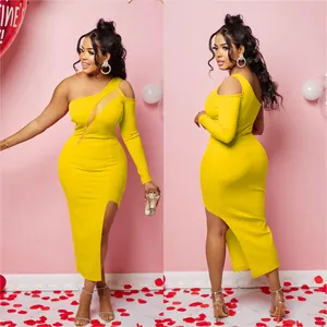 Close-up of elegant yellow one-shoulder midi dress with mesh cutout and side slit.