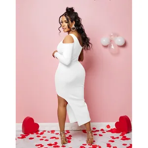 Side view of white one-shoulder dress showing asymmetrical hem and romantic studio setting