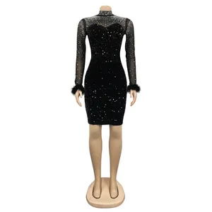 Front view of black long-sleeve rhinestone mini dress featuring feather cuffs on mannequin stand