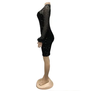 Elegant side view of black rhinestone bodycon dress with mesh sleeves and feather cuffs