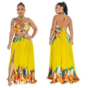Vibrant yellow floral halter maxi dress with backless tie design and side slit.