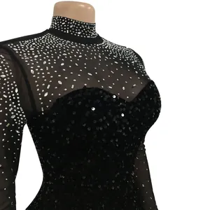 Close-up detail of black sheer long-sleeve dress with sparkling rhinestones and sequins