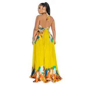 Back view of a vibrant yellow halter-neck maxi dress with colorful abstract prints