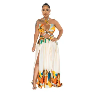 Vibrant abstract print halter maxi dress featuring a cutout front and high side slit detail.