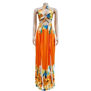 Close-up detail of vibrant orange tie-dye cutout maxi dress with side slits on mannequin