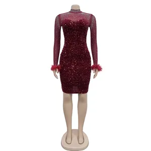 Close-up of wine red sequin dress featuring sheer sleeves and elegant feather cuffs