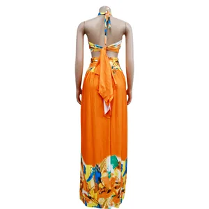 Back view of chic orange sleeveless color-block halter neck maxi dress for women