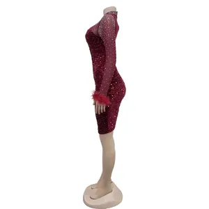 Side view detail of red sequined dress with sheer rhinestone sleeves and feather cuffs