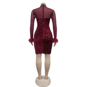 Back detail of wine red sequined mini dress with rhinestone mesh sleeves and feather cuffs