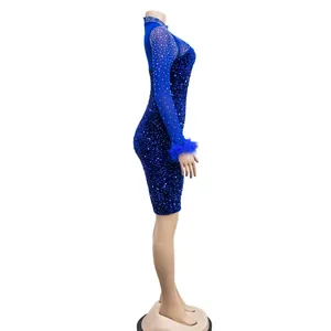 Side view of blue sequin mini dress with sheer rhinestone sleeves and feather cuffs.