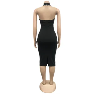 Back view of black halter neck bodycon midi dress with elegant back slit detail.