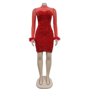 Close-up detail of red sequin dress with rhinestone mesh sleeves and feather cuffs