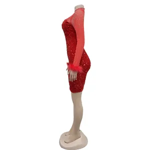 Detailed side view of red sequin mini dress with mesh sleeves and feather cuffs