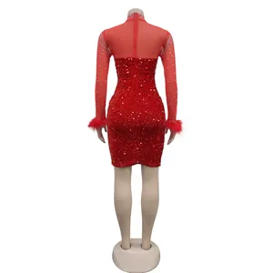 Detailed back view of a red sequined mini dress with sheer mesh panel and feather cuffs