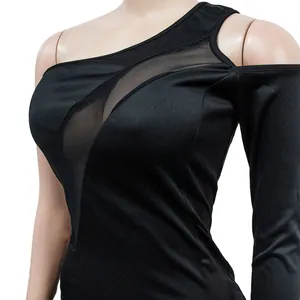 Close-up of black one-shoulder dress featuring sheer mesh panels and long sleeve