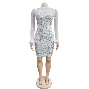 Sparkling white rhinestone mesh long sleeve dress with feather cuffs on mannequin.