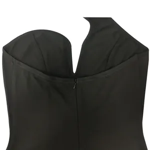 Detailed close-up of the zipper and neckline on a black halter sleeveless dress
