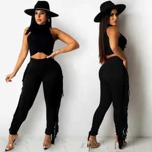 Detailed view of women's black two-piece set with sleeveless top and fringe leggings