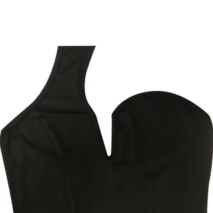Close-up detail of the asymmetrical V-neckline on a solid black sleeveless dress
