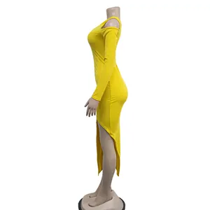 Side profile detail of yellow asymmetric long dress featuring one sleeve and slit