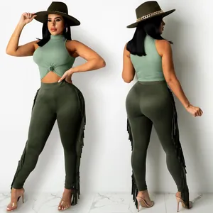 Front and back view of a green sleeveless crop top and fringe leggings two-piece set.