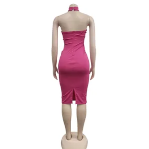 Rear view of a hot pink halter neck bodycon dress featuring a back slit on a mannequin
