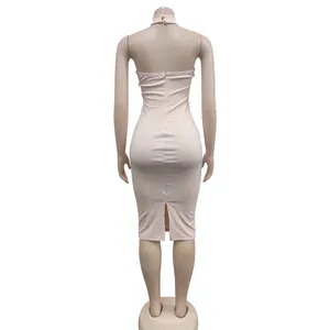 Back view of pink halter bodycon dress featuring a rear zipper and split hem