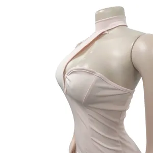 Detail view of pink halter neck sleeveless dress with cutout design on mannequin.