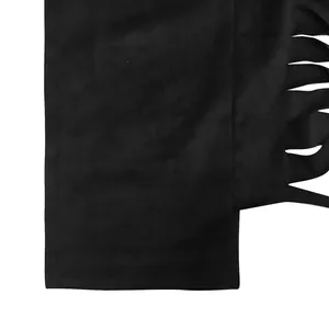 Close-up of the fringe tassel detail on the black fabric of the two-piece fashion set