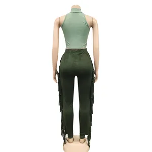 Back view of a two-piece set featuring a green sleeveless crop top and fringed leggings