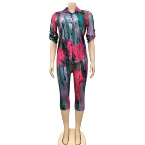 Detailed view of a vibrant abstract print two-piece shirt and cropped pants set.