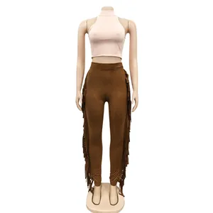 Detailed view of women's two-piece set featuring pink crop top and brown fringe leggings
